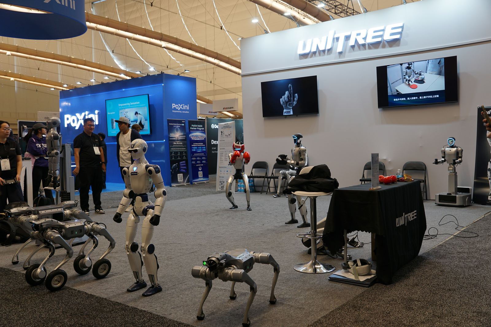Unitree booth with humanoids and quadrupeds.