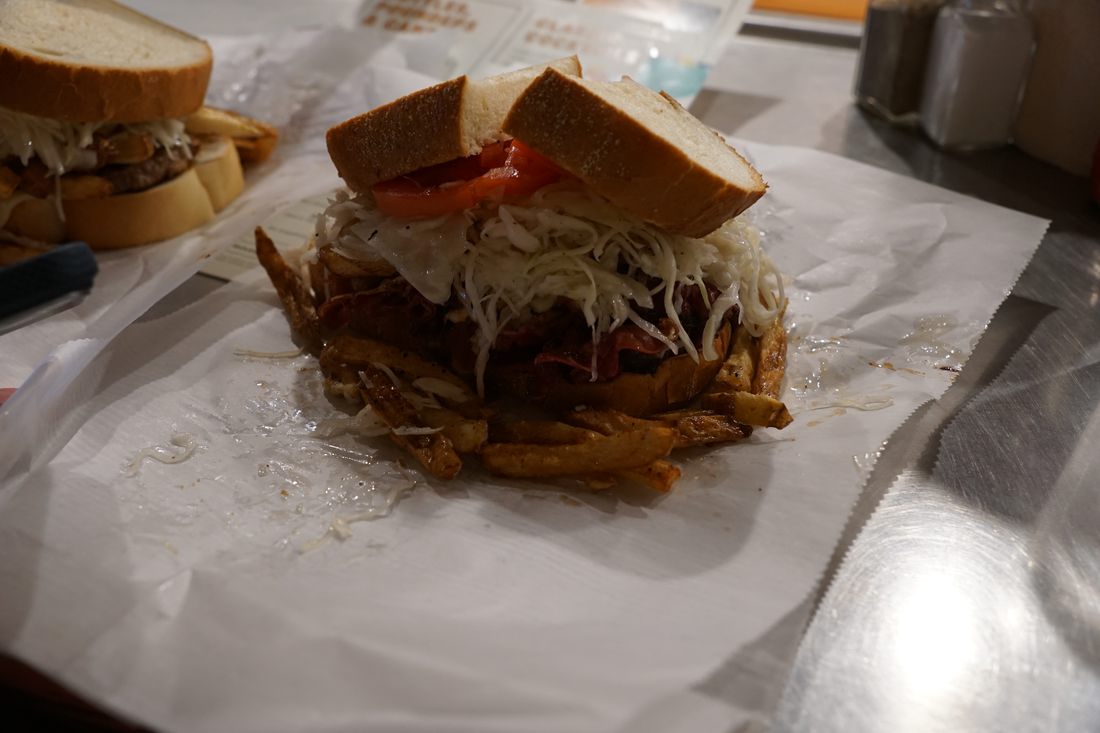 Primanti Bros sandwich stacked with meat, slaw and fries.