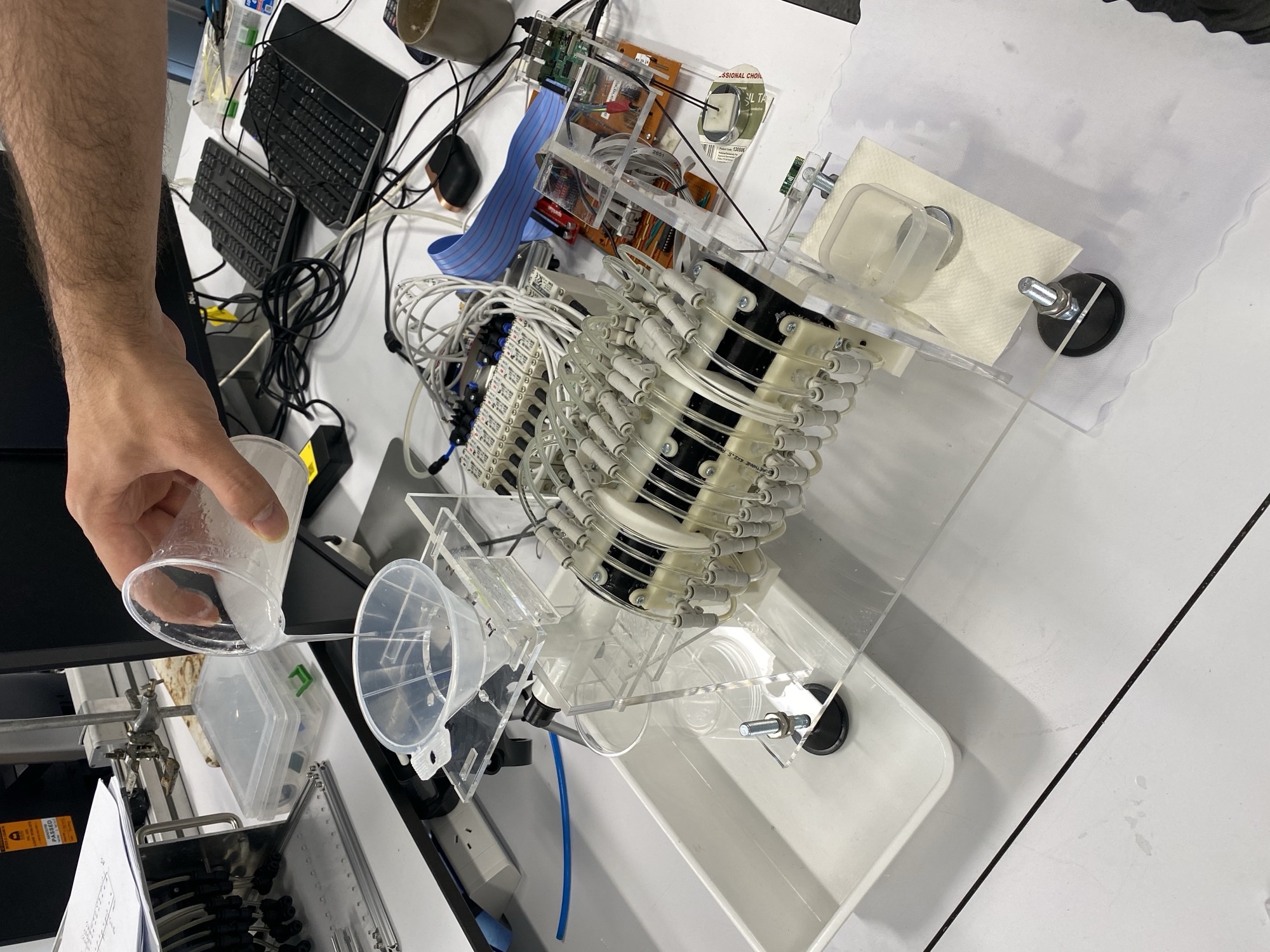 Full RoSE benchtop setup: starch-thickened bolus poured into funnel for peristaltic transport, with pneumatic valves and control electronics